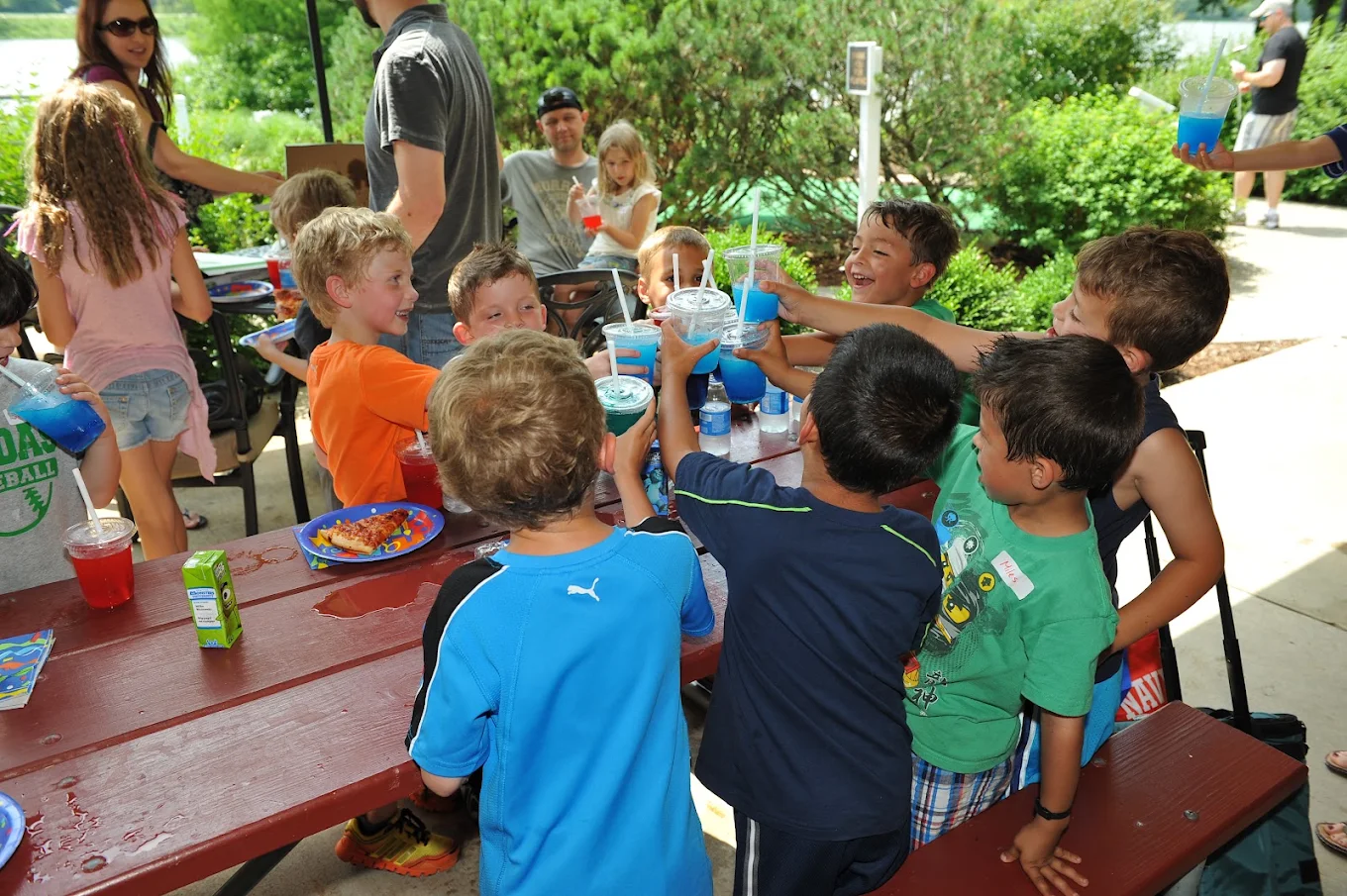 A birthday group cheering with drinks in the River View courtyard