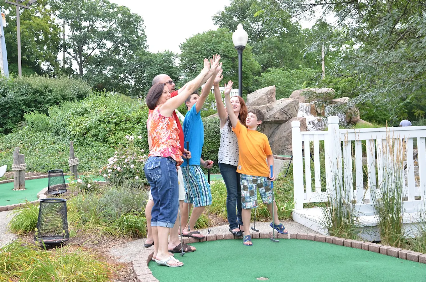 A family celebrating on the course at River View Miniature Golf
